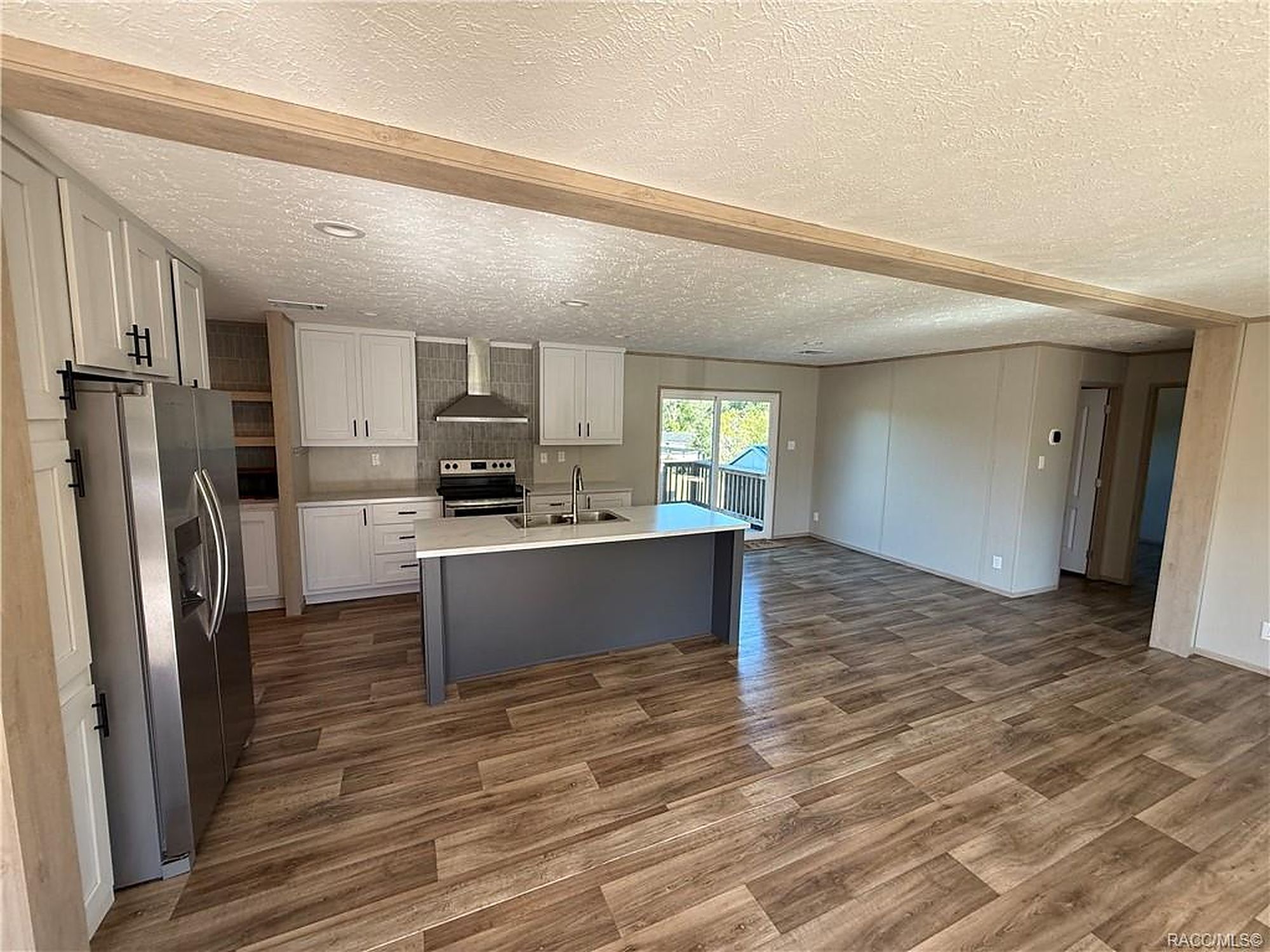 Open kitchen and living area with quartz island inside a Roam Management rental